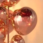 Luxury modern floor lamp with rose gold glass orbs – artistic designer lighting fixture for contemporary interiors, ambient glow decor piece for living room or hotel lobby.