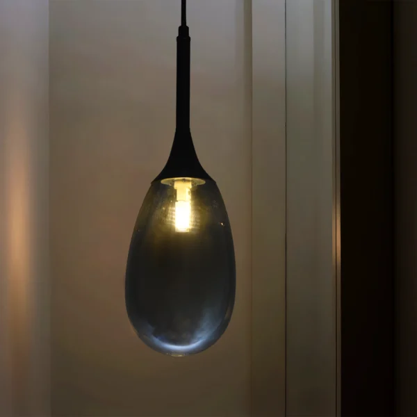 Modern smoked drop glass pendant lamp for kitchen islands, dining rooms, and luxury interiors – stylish hanging light fixture with smoky grey finish and ambient LED glow.