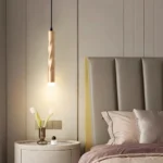 Modern gold twisted pendant light, brass finish, cylindrical hanging lamp.