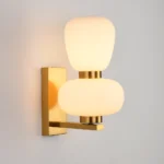 modern double orb wall lamp, stacked frosted glass sconce, polished brass finish, minimalist decorative lighting, contemporary bedside fixture
