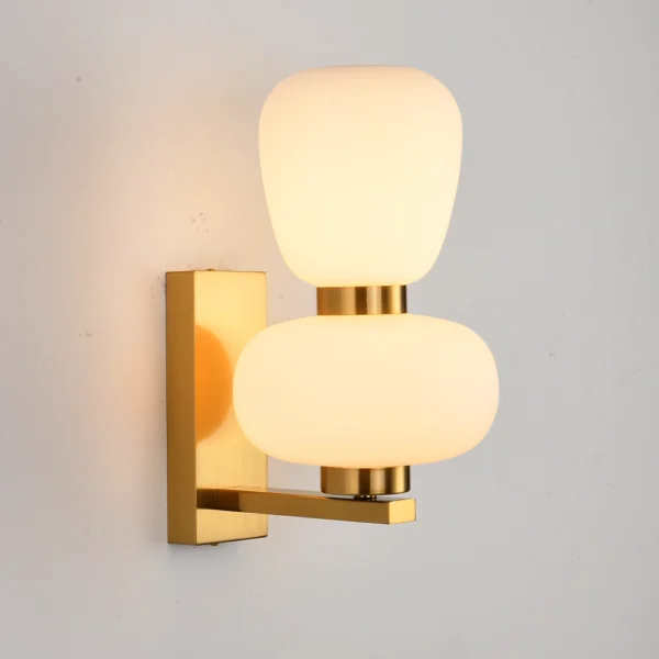modern double orb wall lamp, stacked frosted glass sconce, polished brass finish, minimalist decorative lighting, contemporary bedside fixture